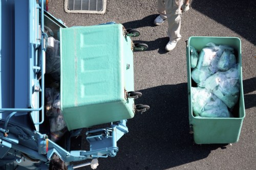 Workers inspecting a skip before loading